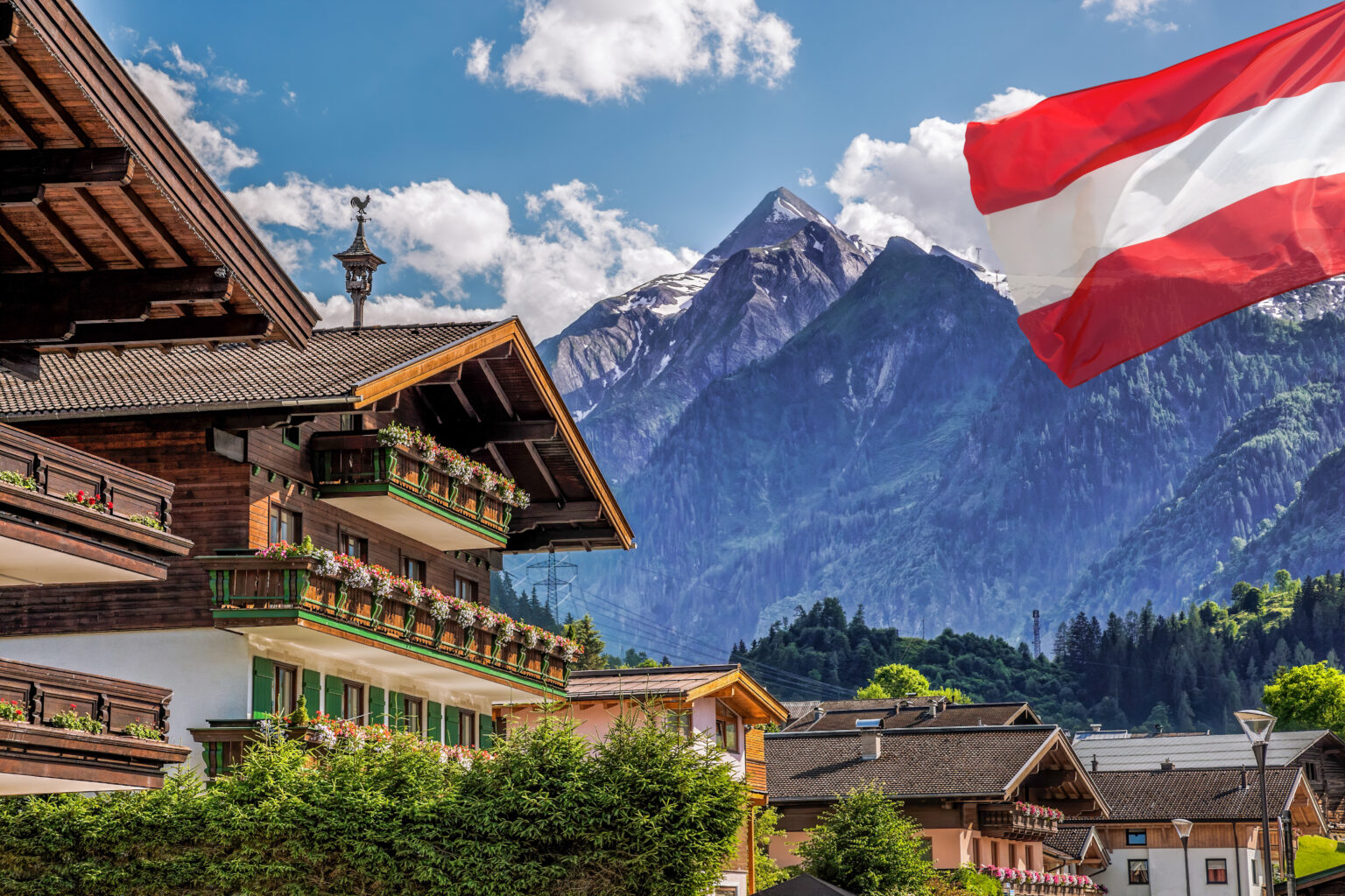 Kaprun,Village,With,Hotel,Against,Kitzsteinhorn,Glacier,And,Austrian,Flag